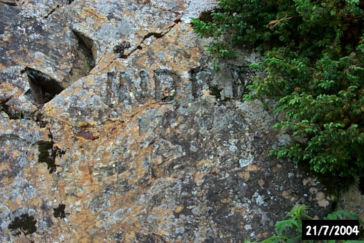 Inscription on a rock face: 'INDRE 1880' - the name of a ship and the year it visited Croque.
